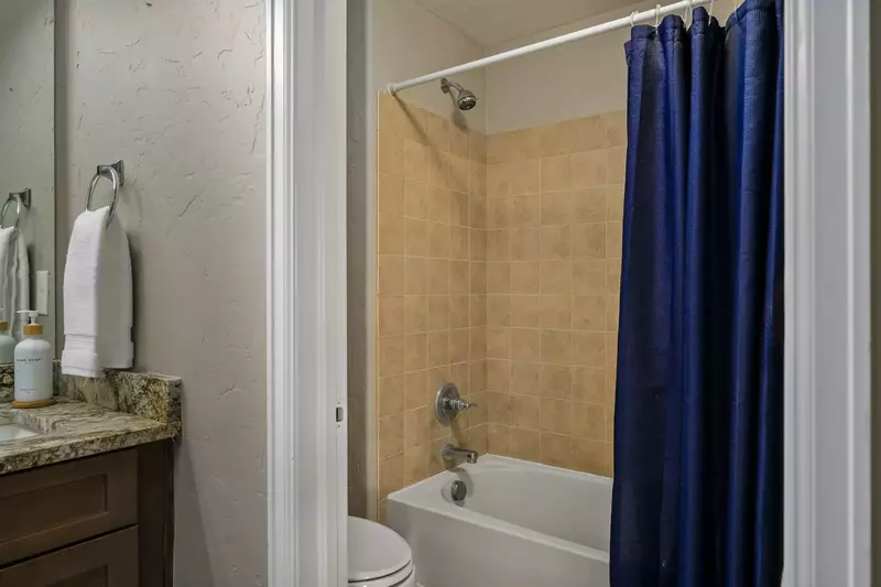 Another bathroom featuring a shower with robust water pressure.