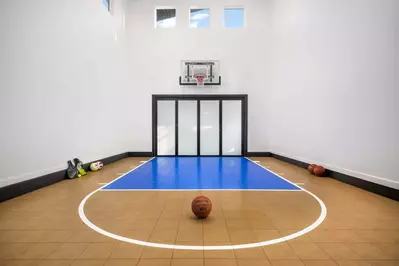 The basketball court is a great place to shoot hoops, but it has other game equipment as well.