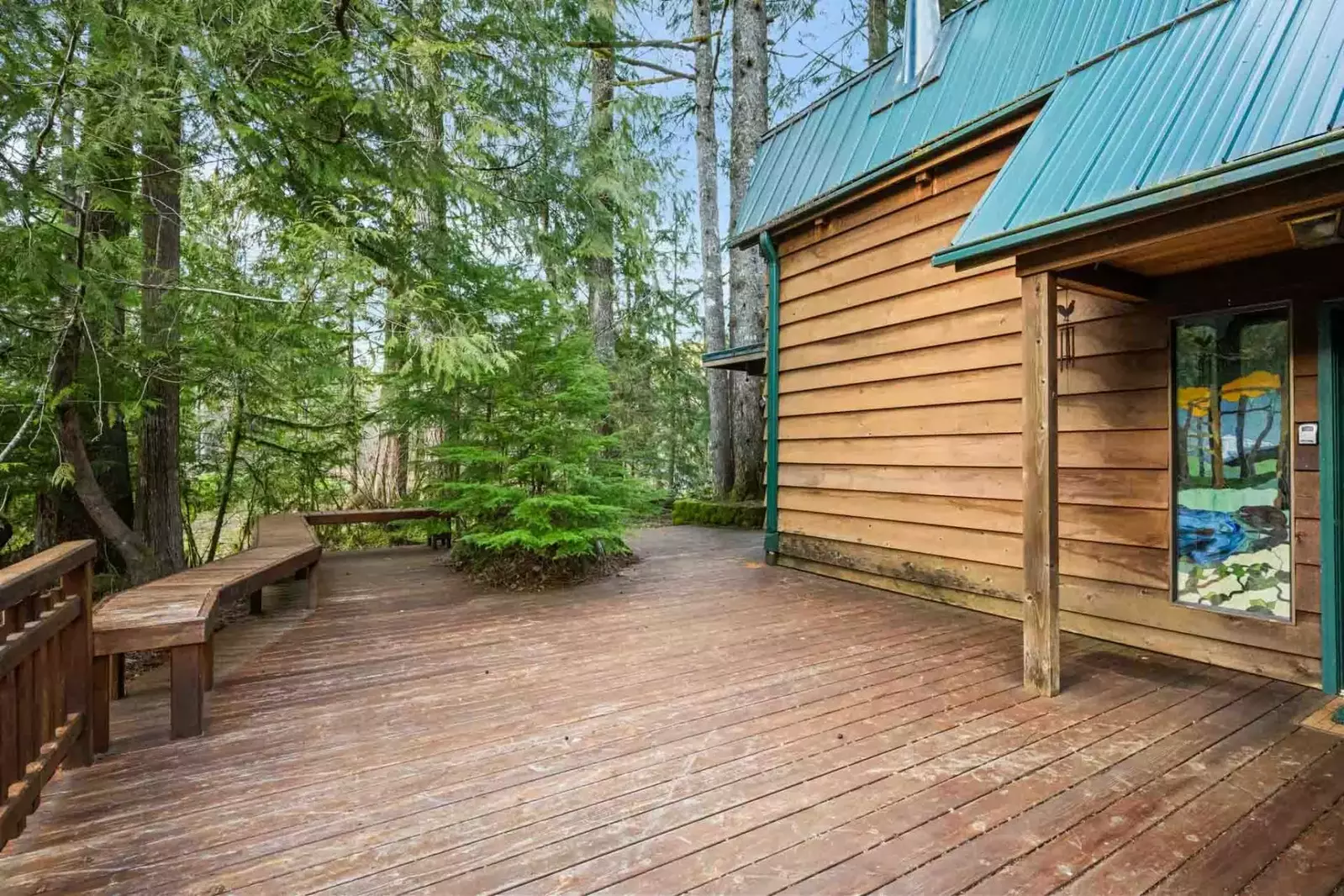 The deck at Crystal Creek Cabin is large and brings guests right into the forest.