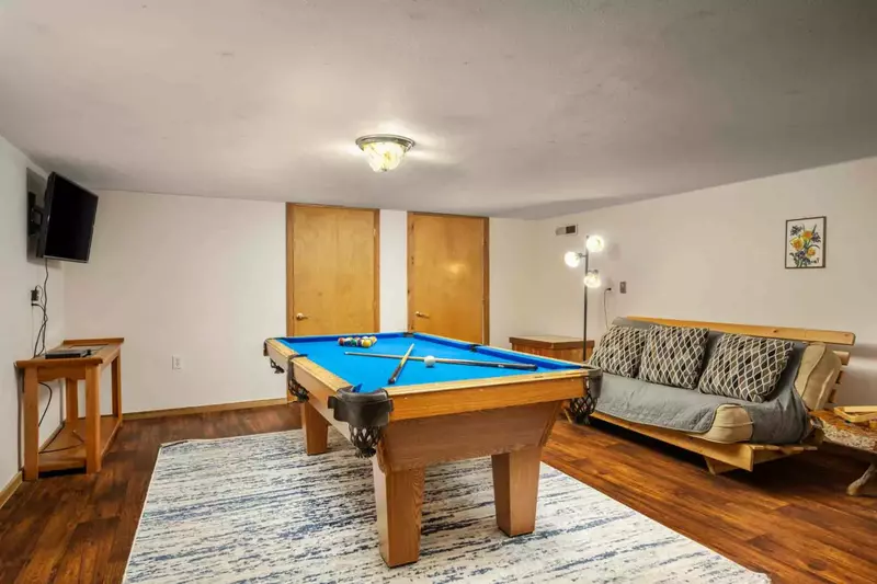 Watch the smart tv while playing a game of pool.