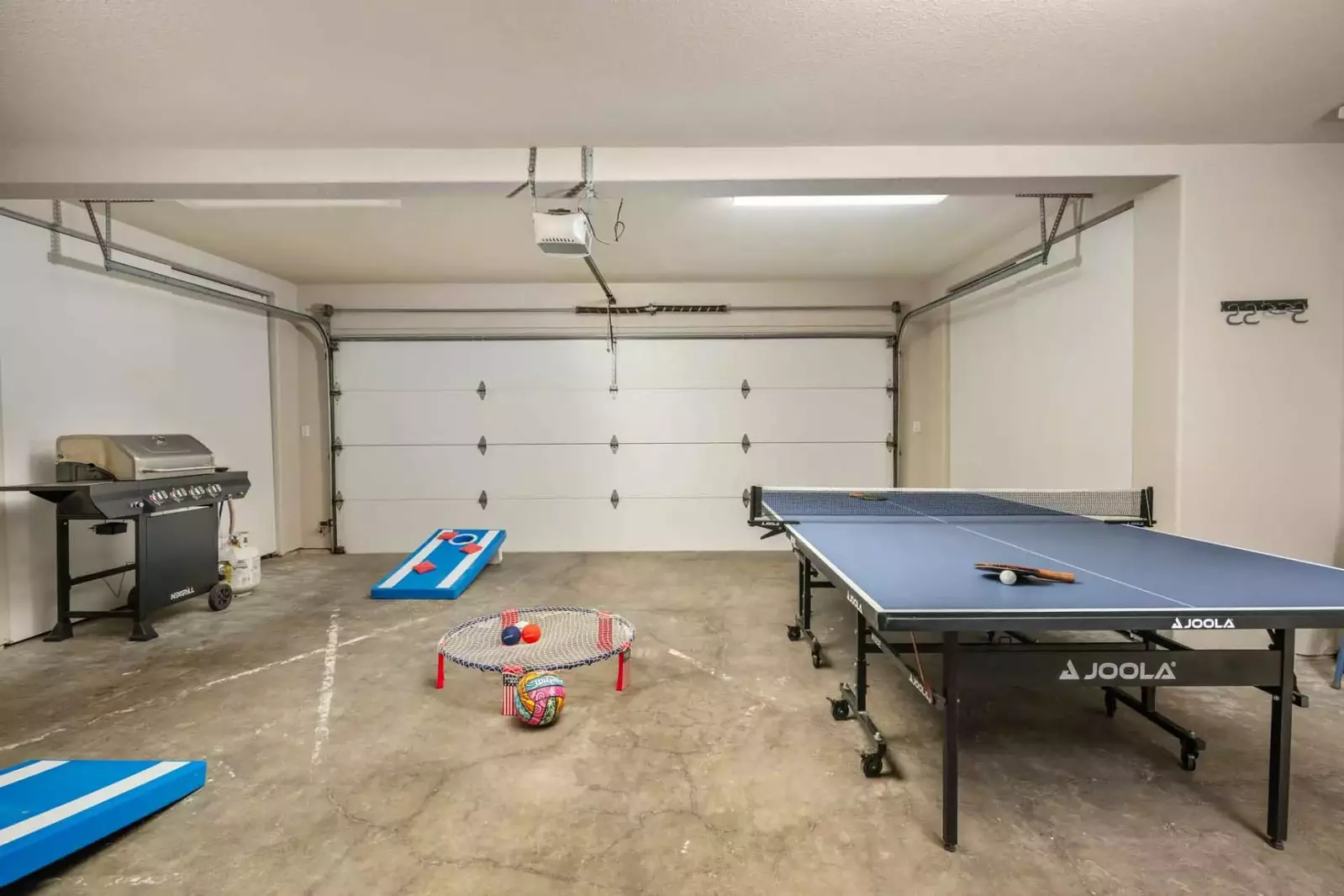 The game room is full of activities like ping pong, cornhole, spikeball, a bbq, and more!