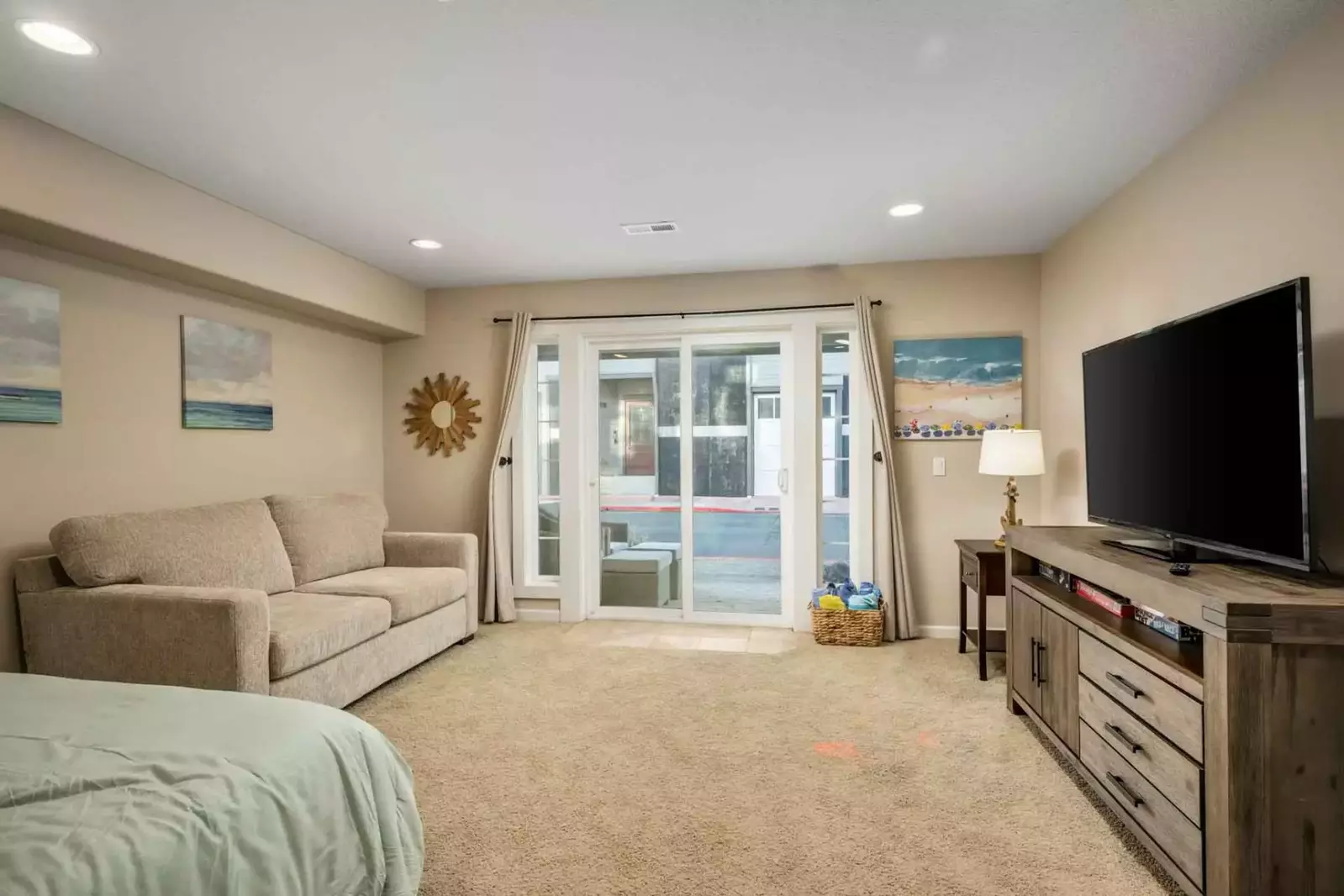 This room has a smart tv, comfy bed, and quick access to the outside.