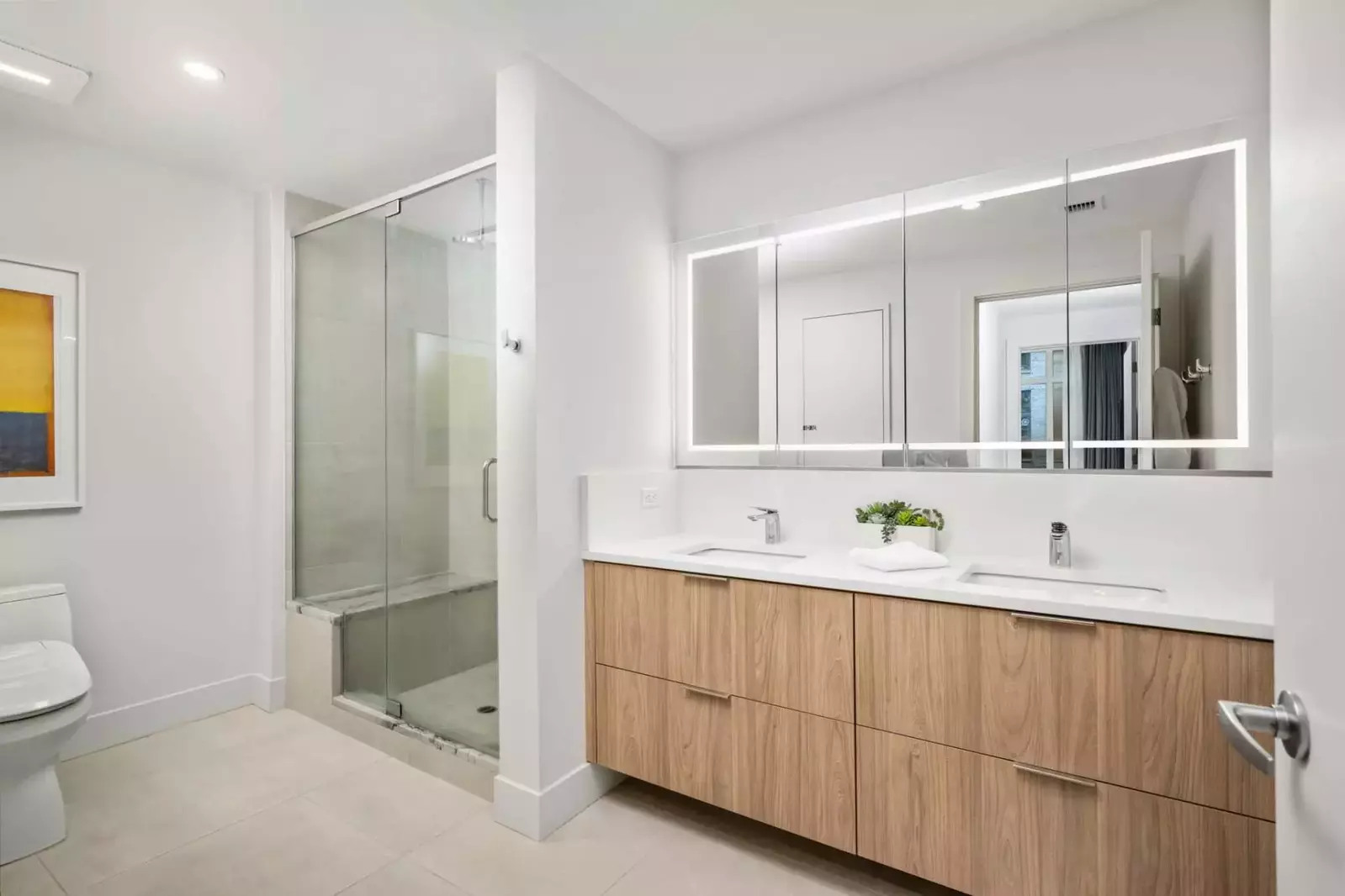 This bathroom has two sinks and a shower with excellent water pressure.