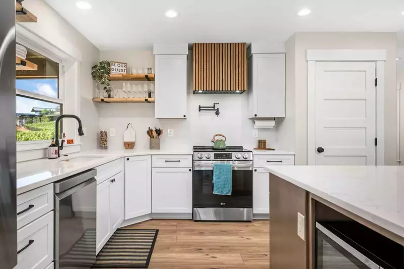 Enjoy this gourmet chef's kitchen with amenities such as an electric range, Instant Pot, blender, air fryer, crock pot and high end cookware.