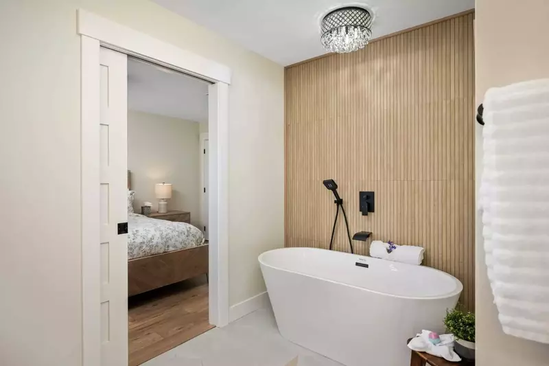 Primary en suite bathroom includes soaking tub, large tile shower