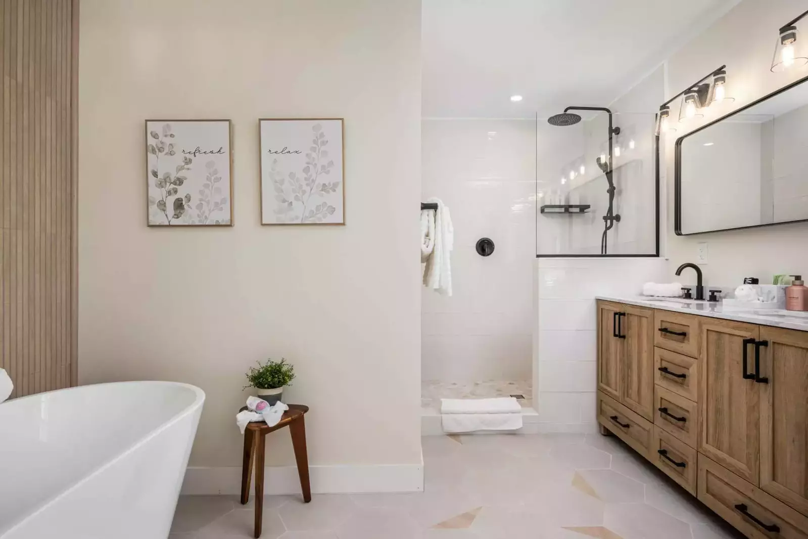 Large custom tile shower in the en suite of the primary bedroom.