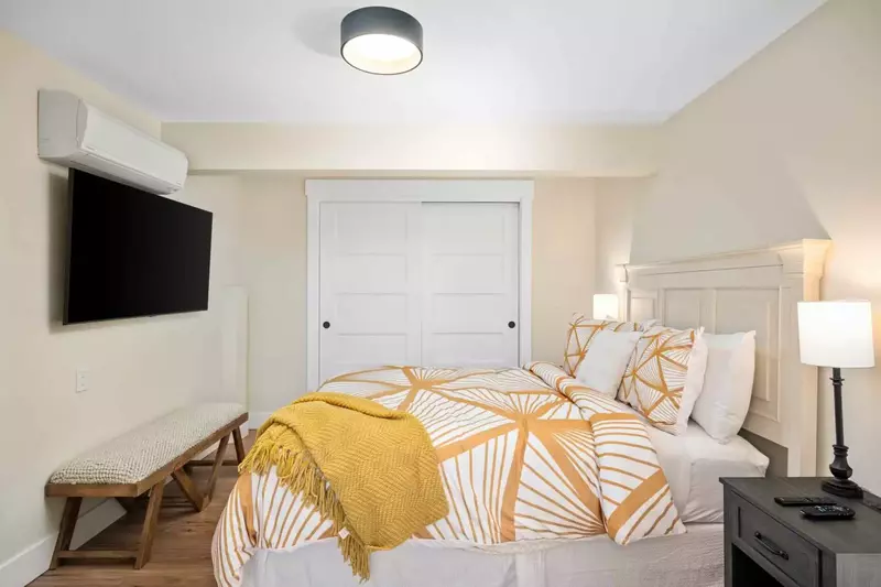 Bedroom with king bed on the lower floor includes individually controlled AC & Heat and Smart TV along with an en suite bathroom