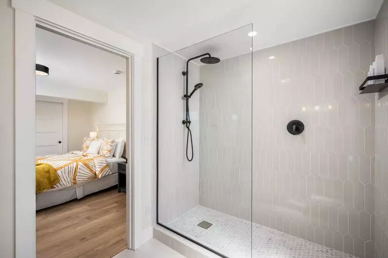 En suite bathroom with large tile work.