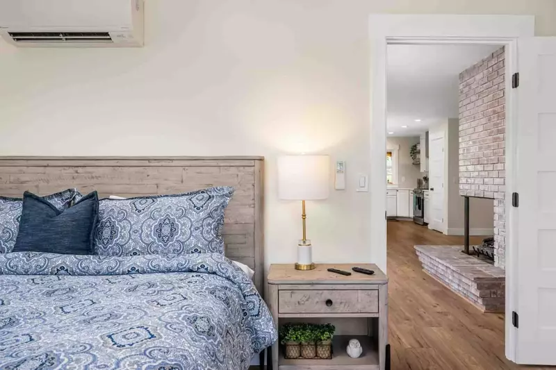 Bedroom with king bed on the main floor includes individually controlled AC & Heat and Smart TV along with an en suite bathroom