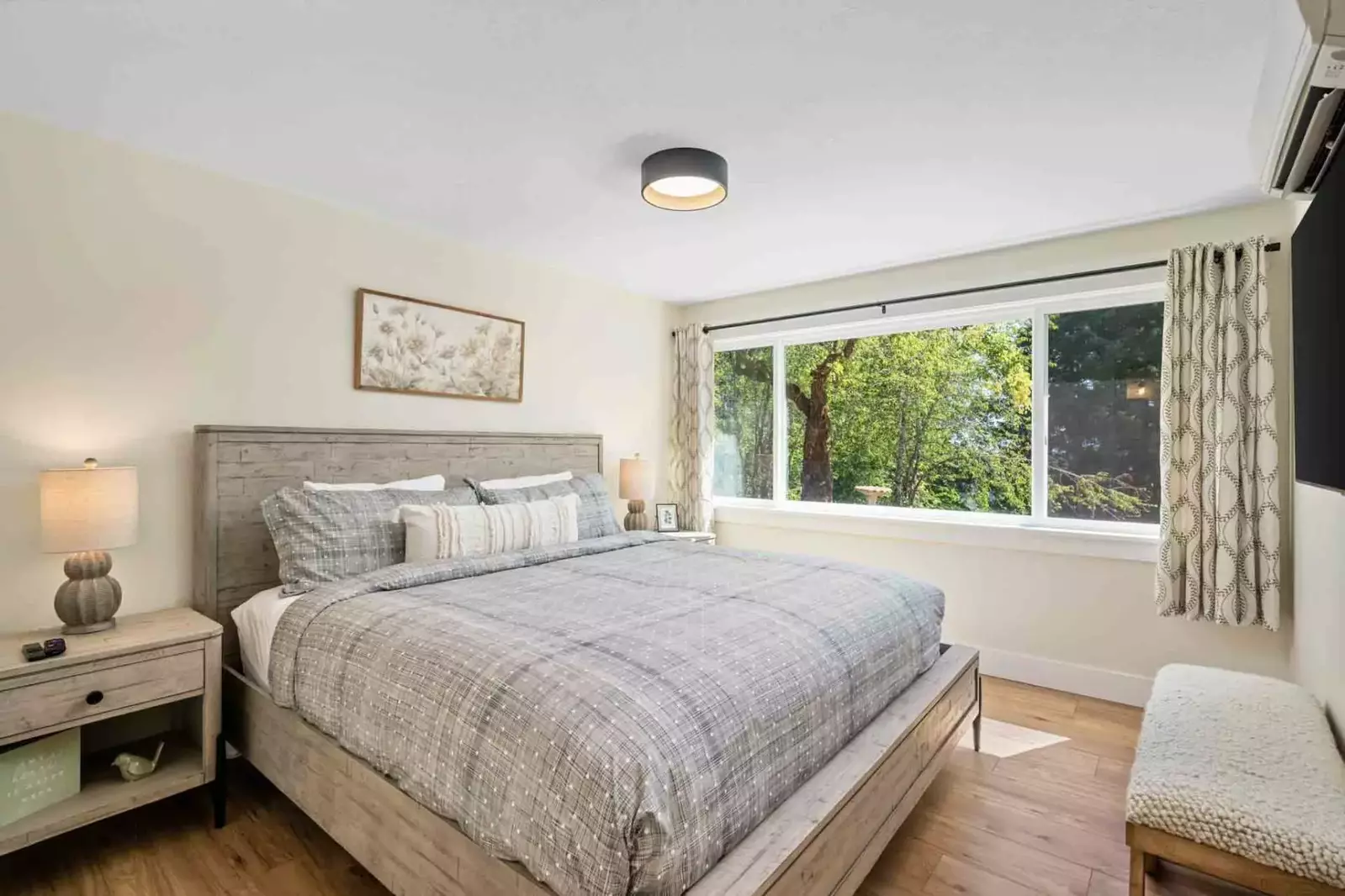 Bedroom with king bed on the lower floor includes individually controlled AC & Heat and Smart TV full bathroom just outside the door