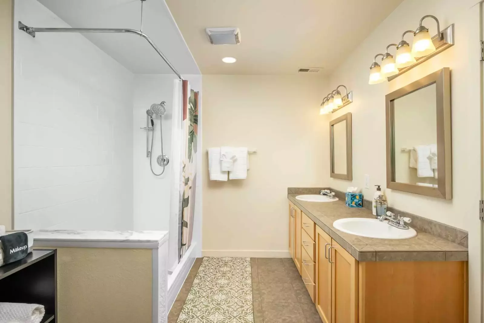 This bathroom has two sinks and a shower with excellent water pressure.