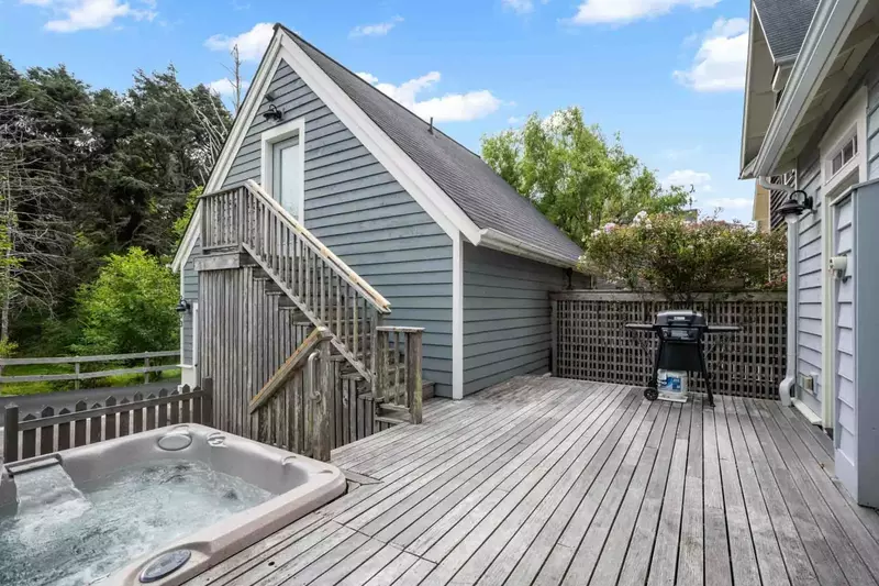 The deck is spacious with a propane grill and a hot tub.