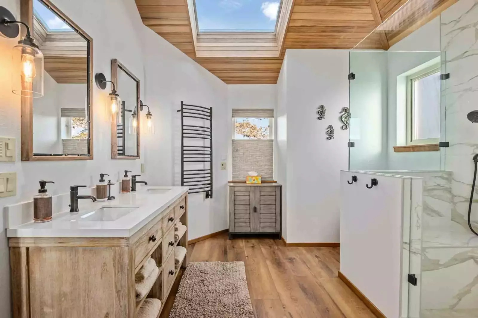 This bathroom has two sinks and a shower with excellent water pressure.