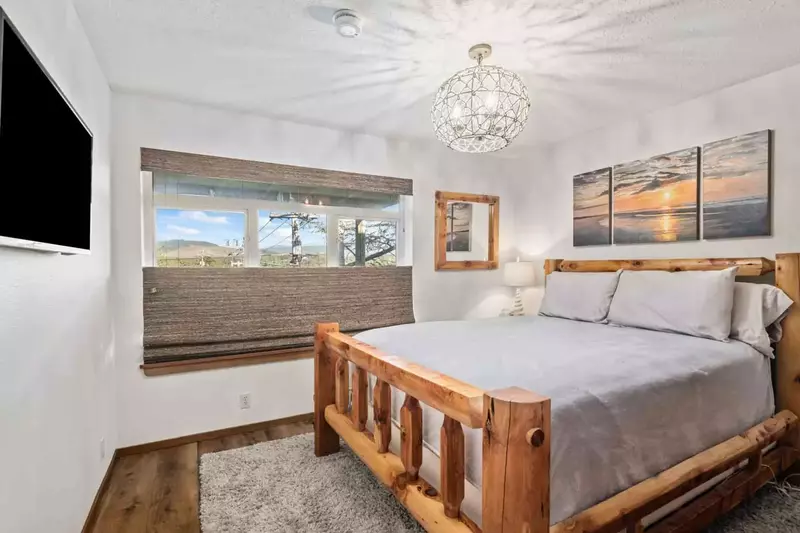 Another bedroom with a comfy bed and a smart tv.