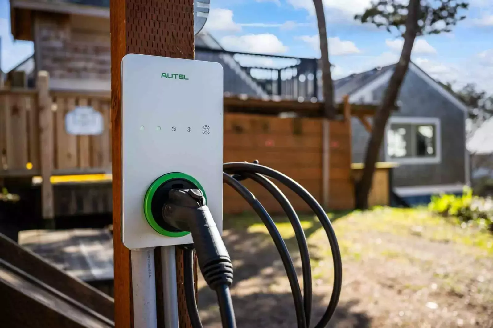 There is a 220 volt EV charger (SAE J1772) located in the parking area.