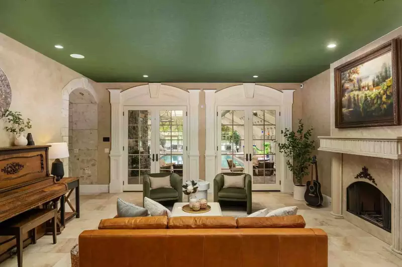 Another cozy room with a fireplace. This one leads right to the pool!