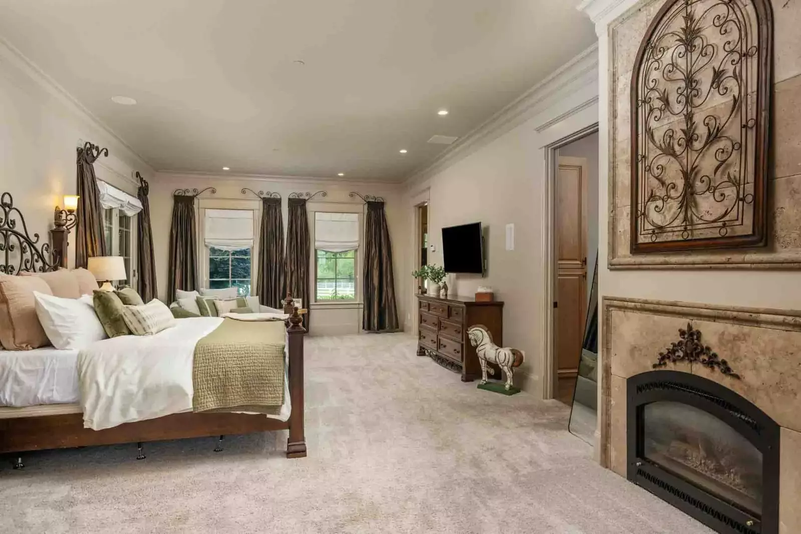 This bedroom is spacious with a fireplace, smart tv, and an incredibly comfortable bed.