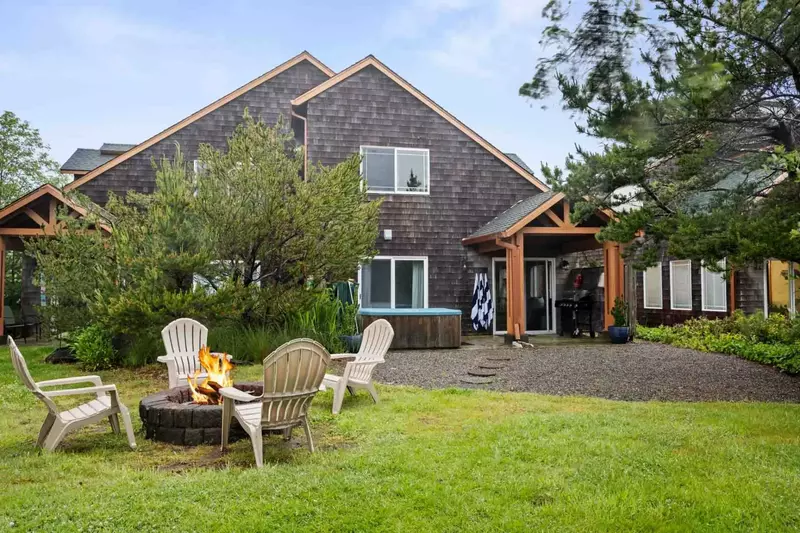 This rental has a spacious yard with a fire pit.