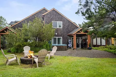 This rental has a spacious yard with a fire pit.