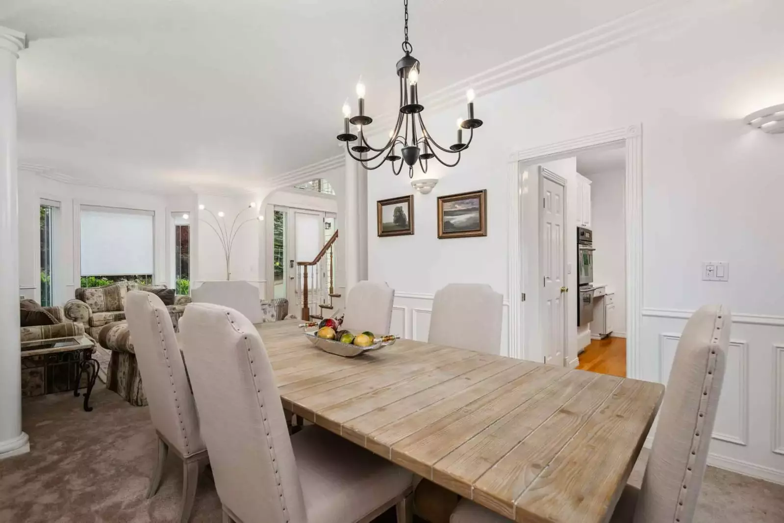 The dining room has comfy seating and a lovely table.