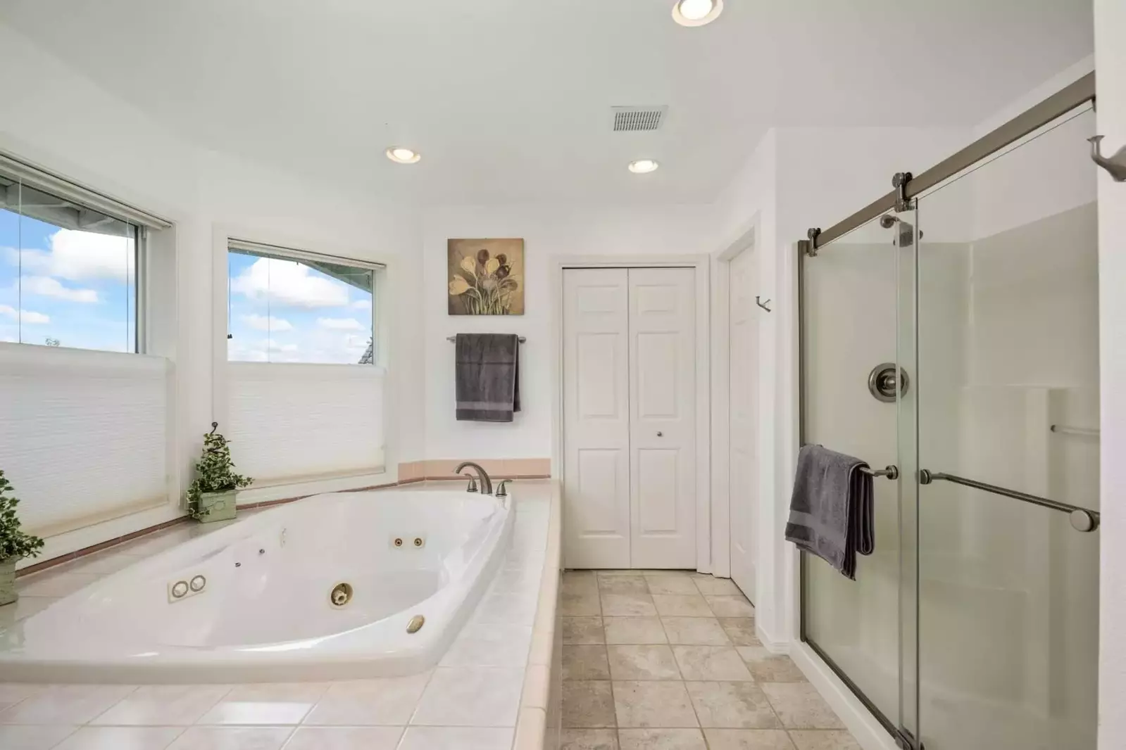 The bath tub has jacuzzi jets.