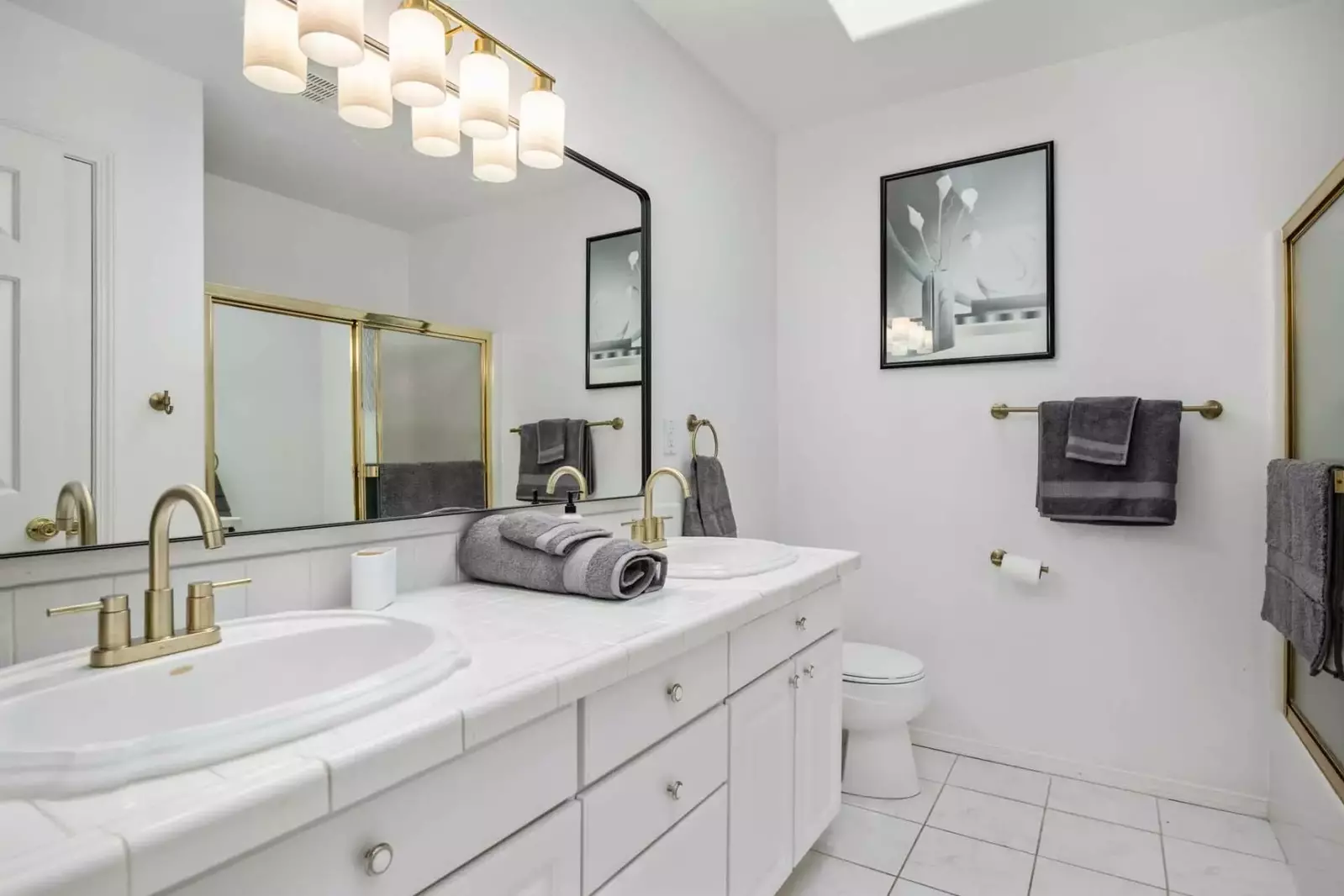 Another bathroom featuring two sinks and a shower with robust water pressure.