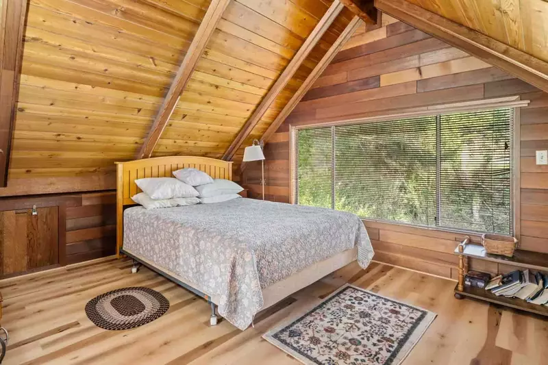 Enjoy staying in the cabin attic with it's lovely forest view.
