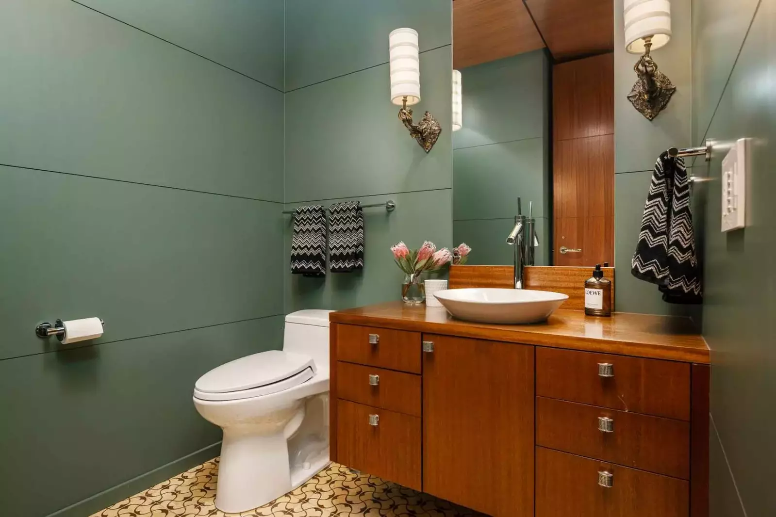 The bathroom is recently updated and ornately decorated.