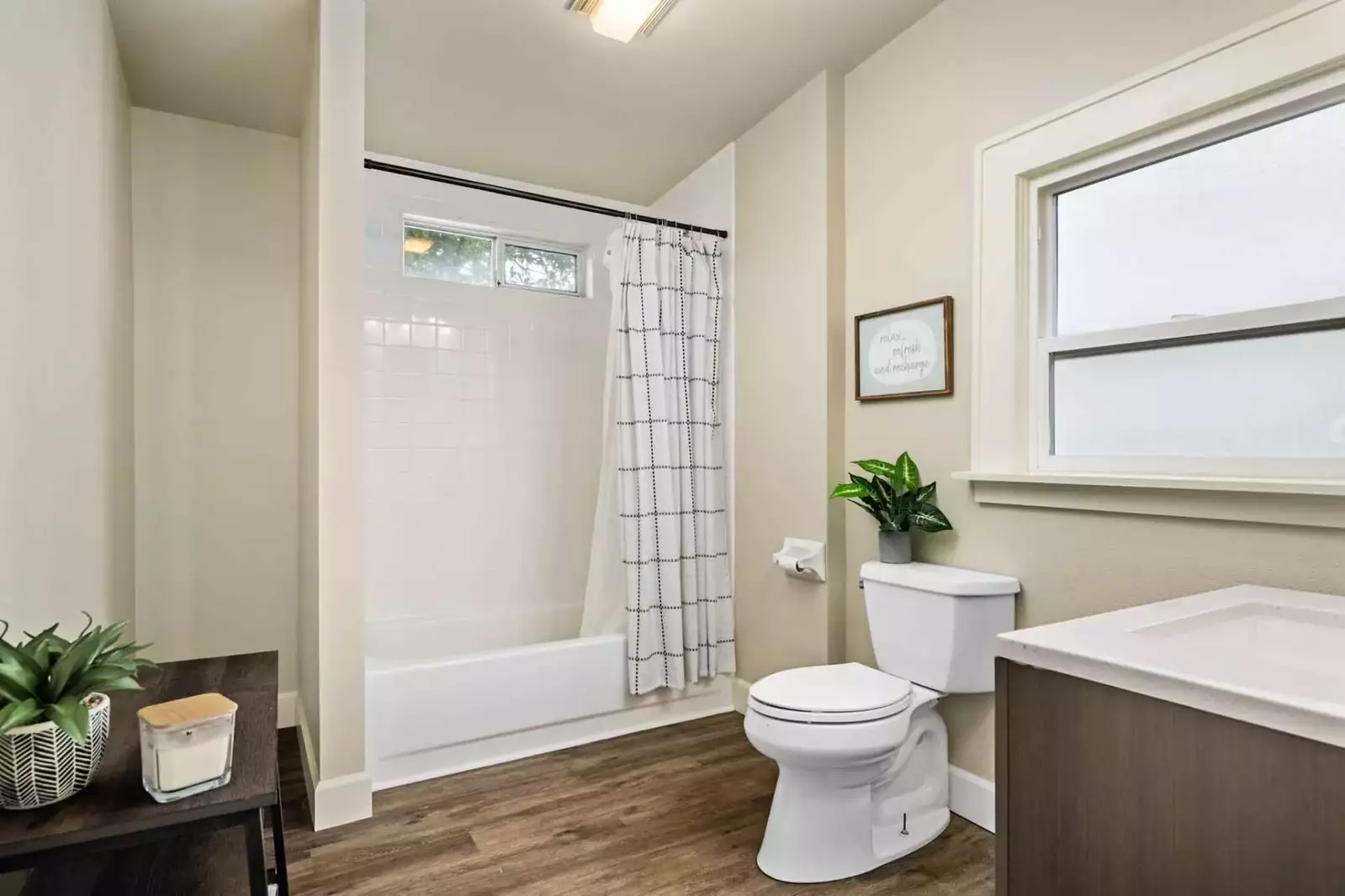 Newly remodeled bathroom with a combo tub and shower.