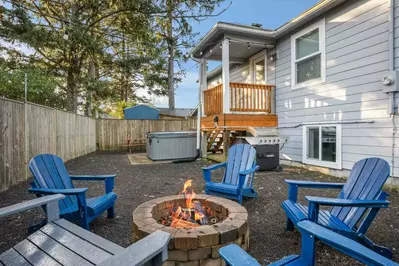 The patio area has a fire pit. bbq, hot tub, and plenty of space to relax.