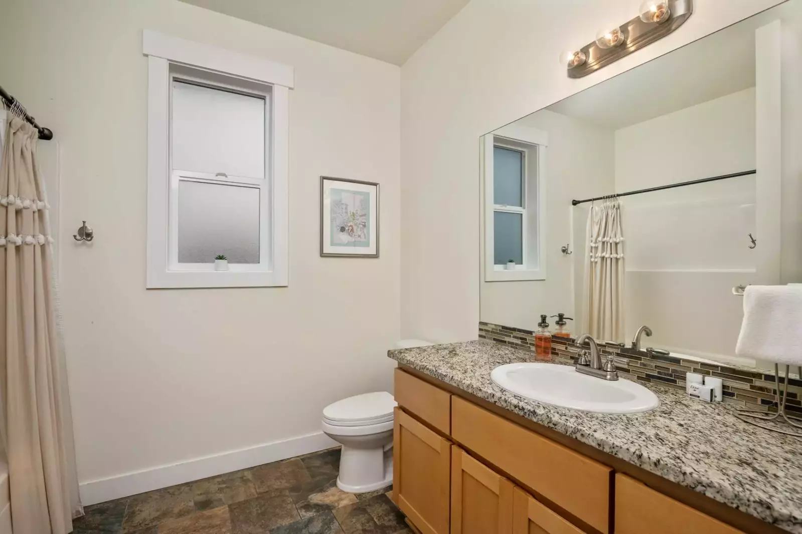 The bathroom is recently updated and decorated.