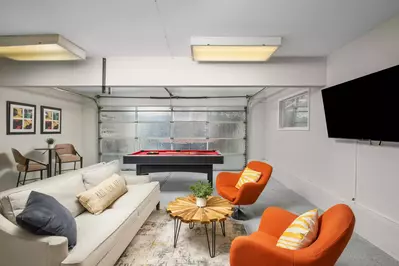 Watch you favorite movies, shows, and sports on this smart tv while you play a game of pool.