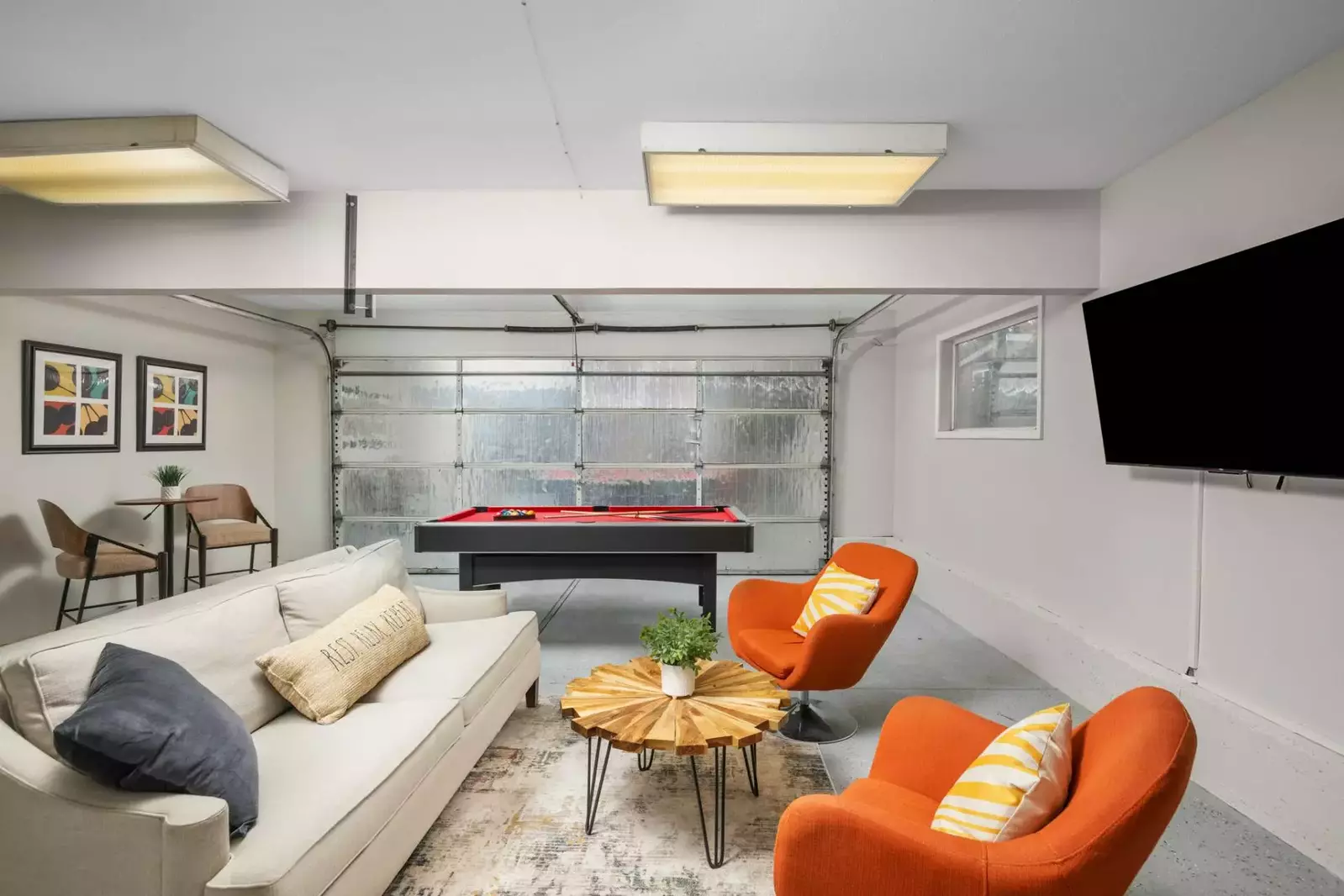 Watch you favorite movies, shows, and sports on this smart tv while you play a game of pool.