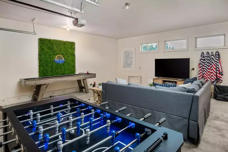 The game room has  ping pong, foosball,  shuffleboard, and a smart tv.