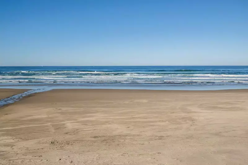 The beach is right outside Beachfront Bliss. It is beautiful whether the weather is chilly or hot.