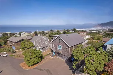 One-of-a-kind beach getaway, which features a private hot tub, ocean views, and space for a large group of 13 guests!