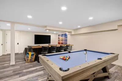 Renovated basement media and game room!  80" TV, cozy seating area, pool table, and beautiful ocean views.