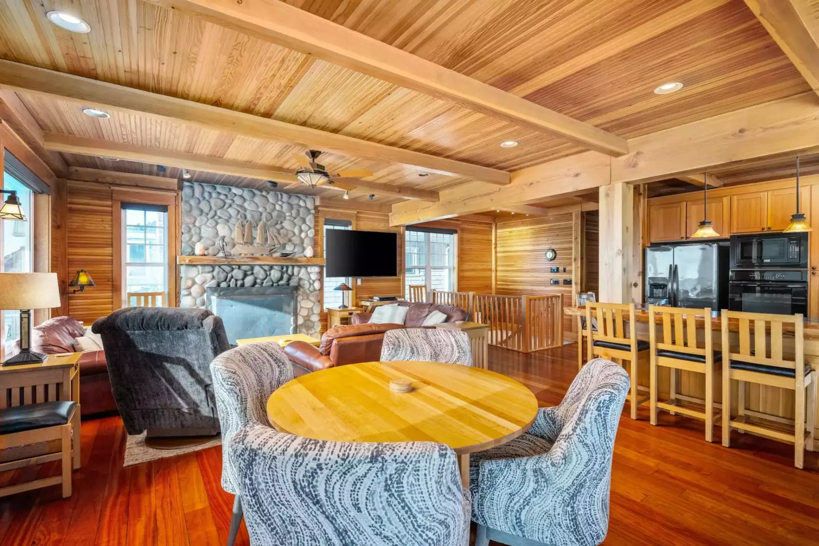 Relax together in the living room on plush leather sofas around the river rock fireplace or enjoy watching the surf from oak Morris rockers.