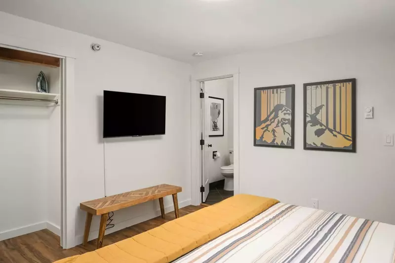 This bedroom features an en suite bathroom, comfy bed, and smart tv.