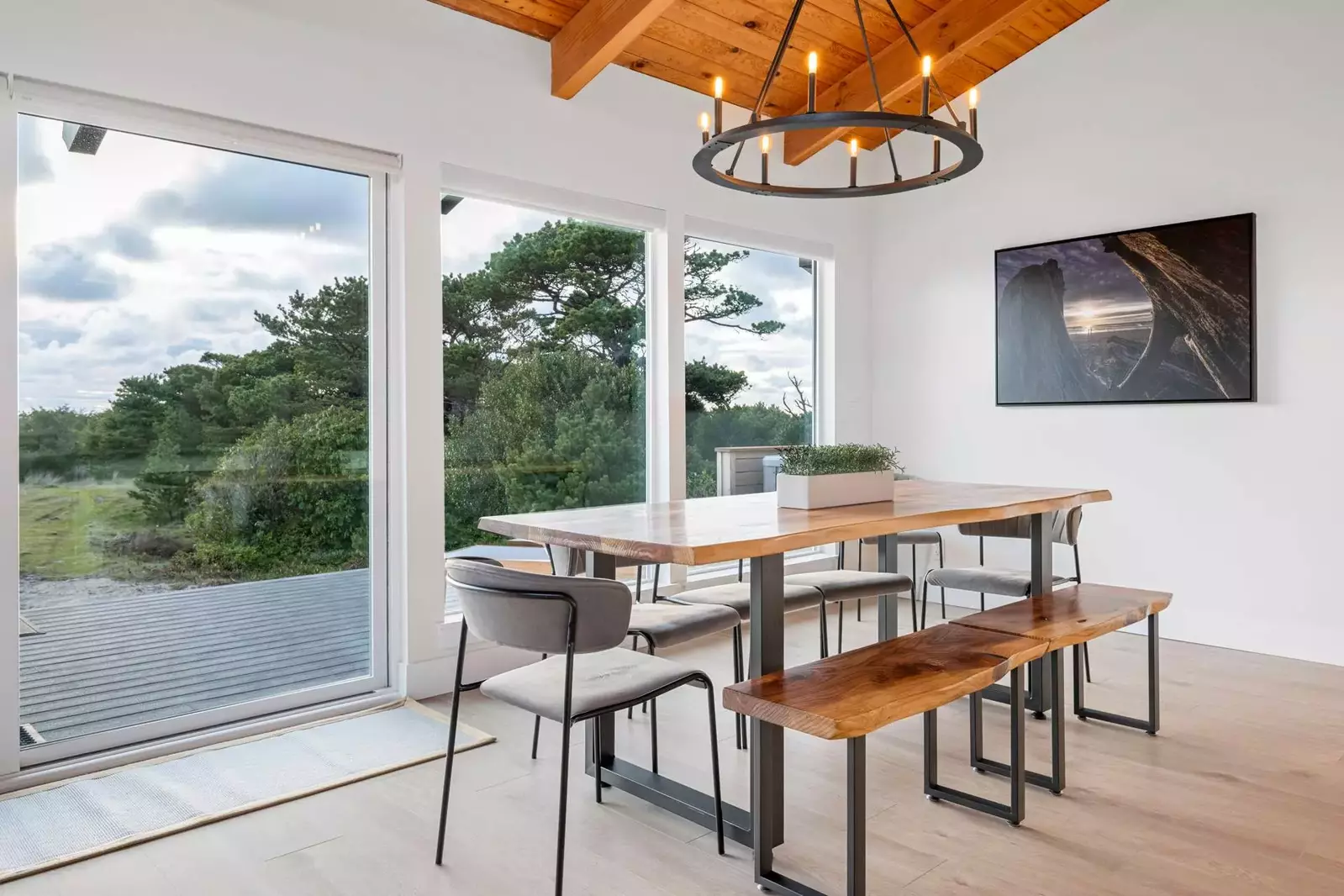 The enormous bank of windows and glass doors bathe the entire space in natural light as well as panoramic ocean and territorial views.