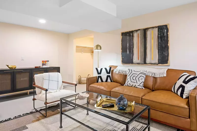 The lower floor includes an additional family room with plush seating, a huge flat screen TV, and gas fireplace for your enjoyment.