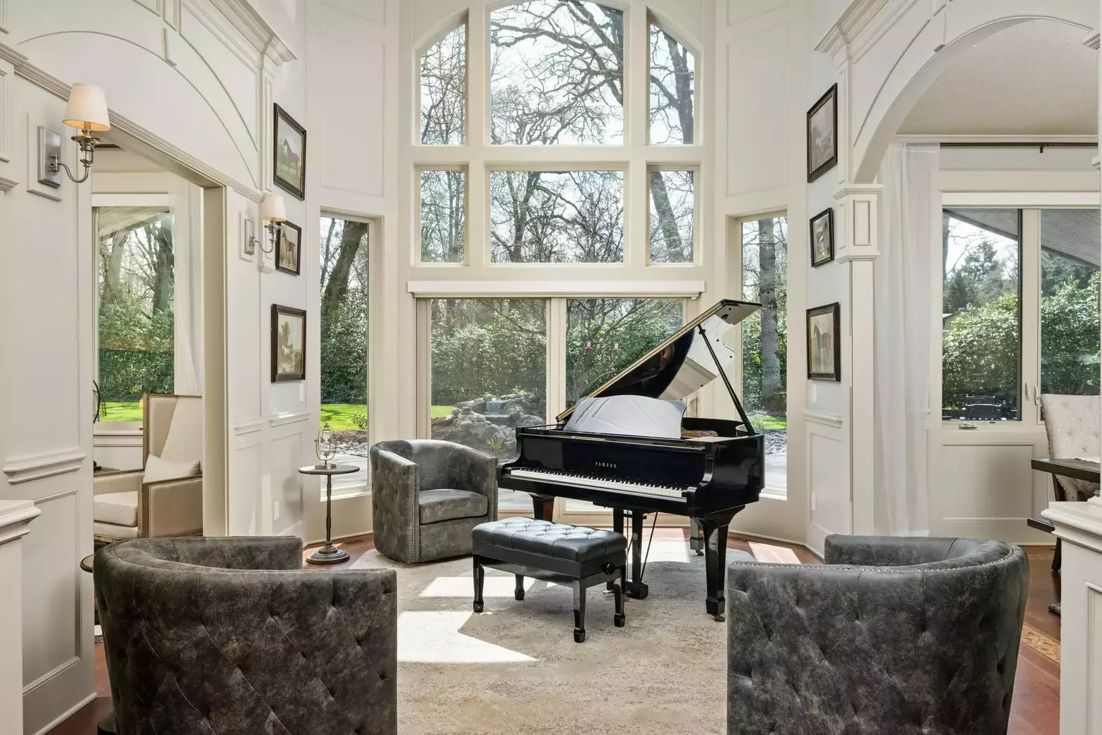 Enter into the gorgeous foyer with its grand piano being bathed in natural light from the enormous bank of windows.