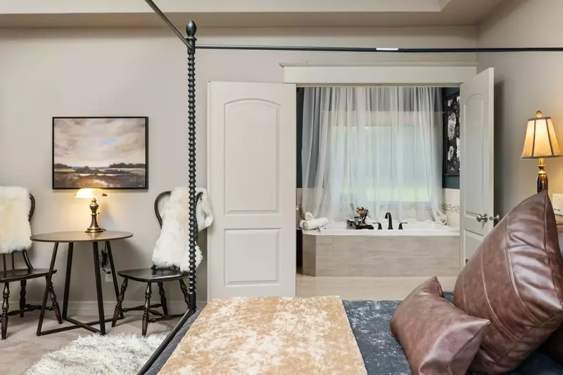 This bedroom features an incredibly comfy bed and a spacious en suite bathroom.