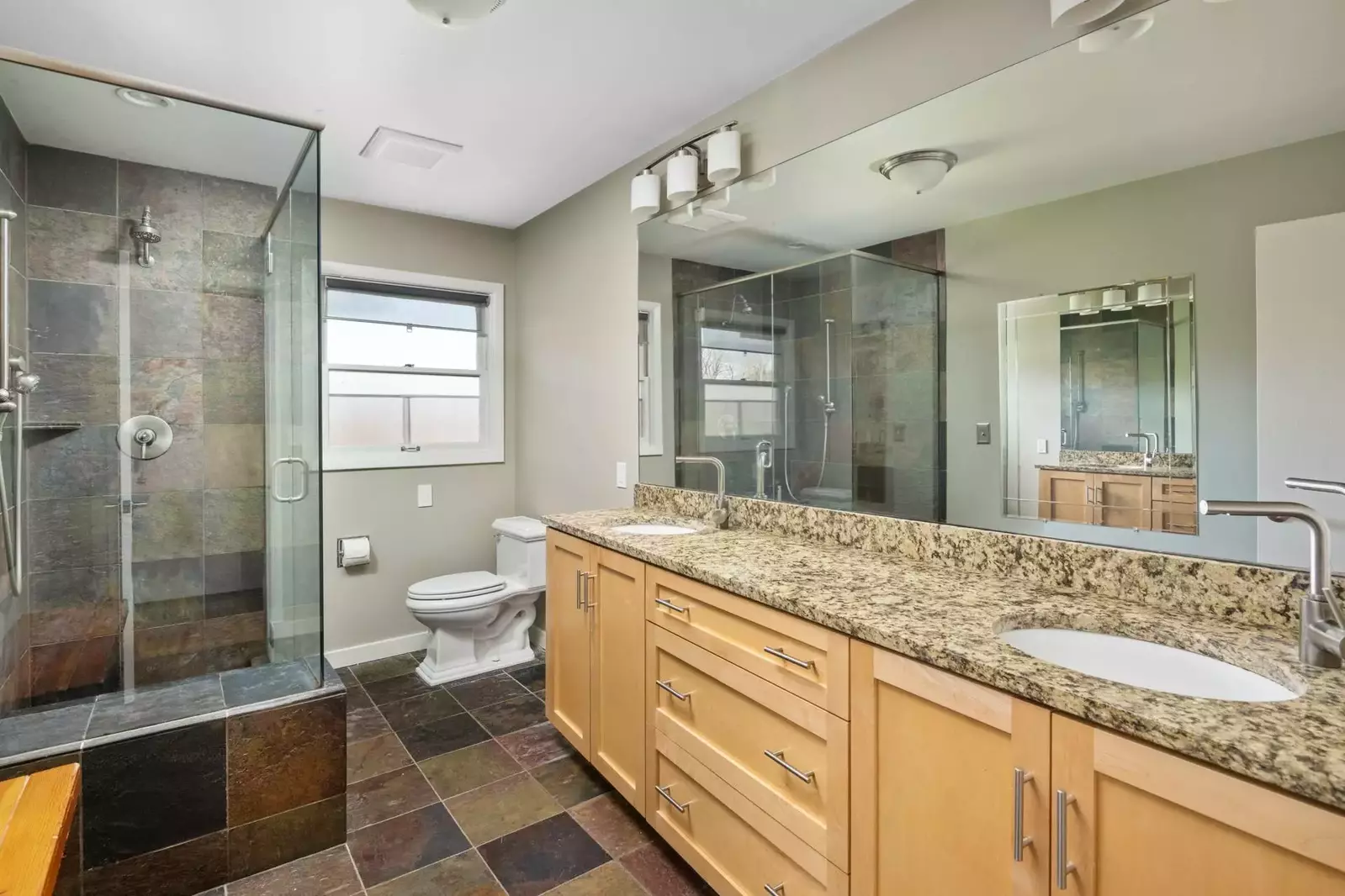 Spacious bathroom with dual sinks and a shower with excellent water pressure.