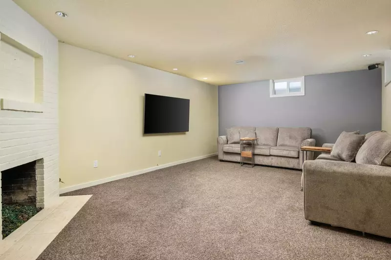 Descending downstairs, you'll find the lower-level lounge and media area.