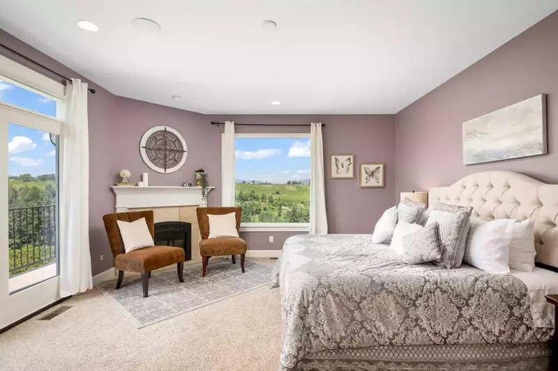 A luxurious bedroom with a king bed, great views, lots of space, a fireplace, and more.