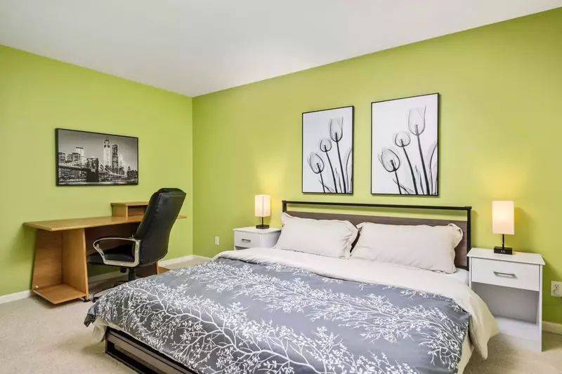 This bedroom has a comfy king bed and a home office set up.