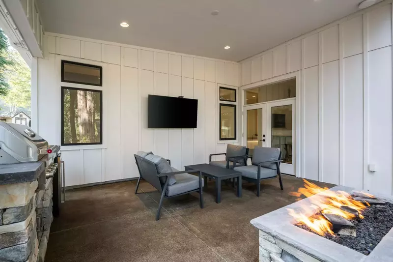 The lovely patio area has a grill, tv, and fire pit.