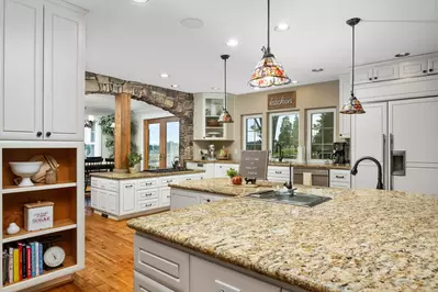 The open layout gourmet kitchen is perfect for your culinary desires. Please note the counters are both average and shorter height.