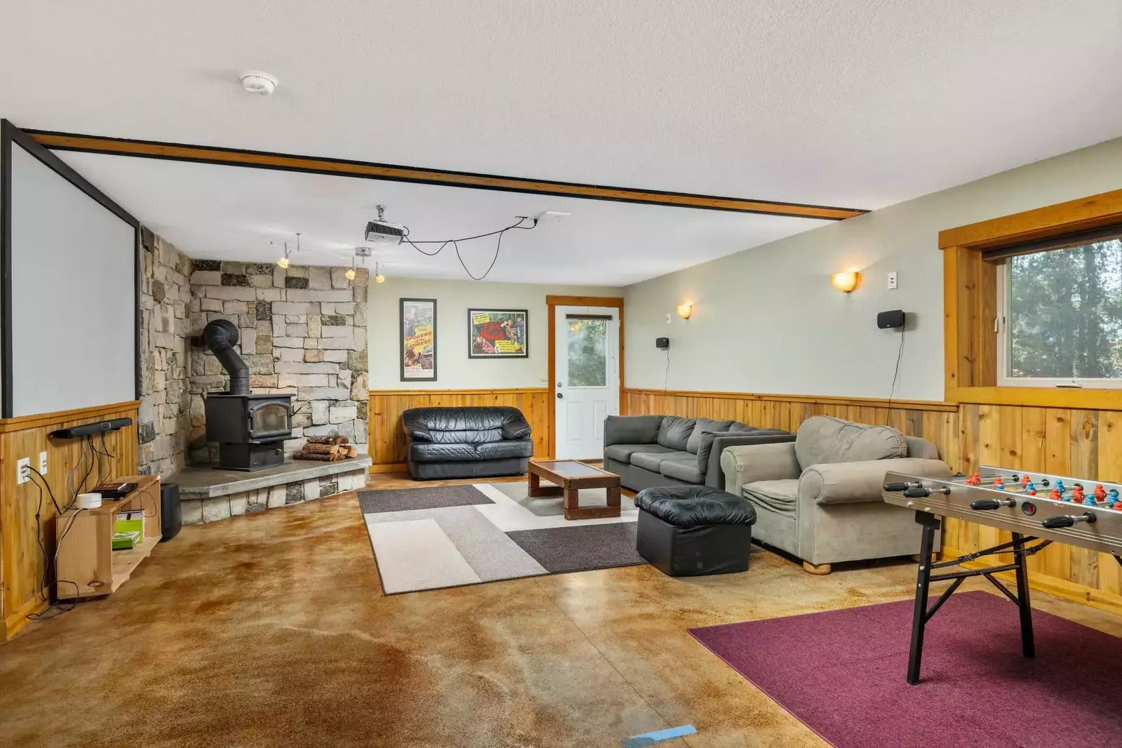 The home theatre has many great features including a projector, foosball table, warm stove, and more!